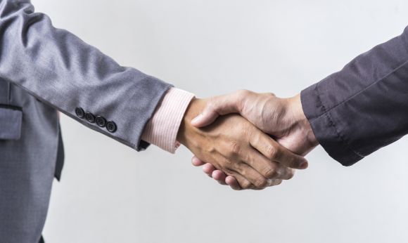 business_handshake_on_grey_background_sbi_301086791.jpg